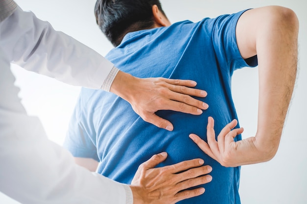 physical doctor consulting with patient about back problems physical therapy 