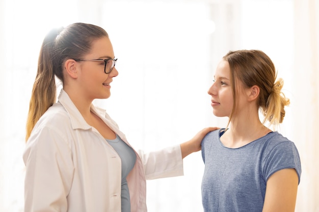 Physical therapist discussing with young woman