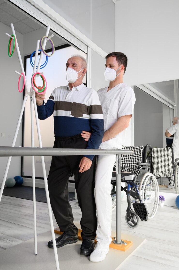 Physical therapist helps stroke victim in rehab center