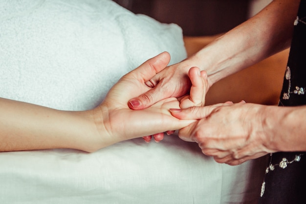 Physical therapist massaging hands