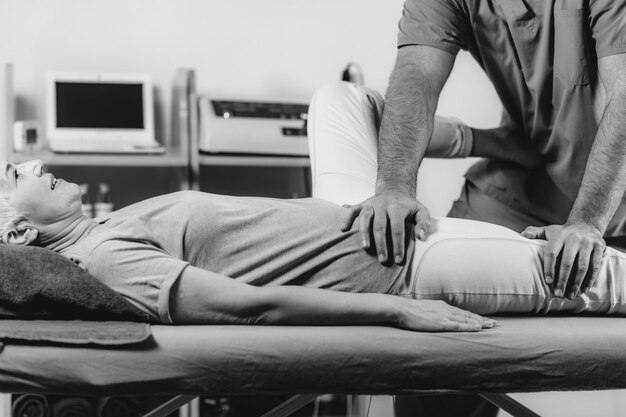 Physical Therapist Working with Leg Senior Woman