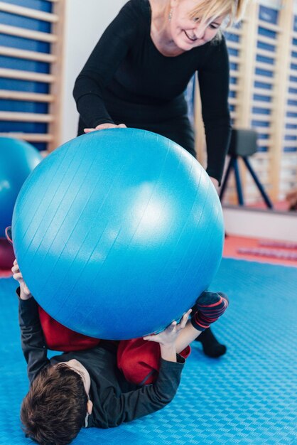 Physical therapist working with little boy