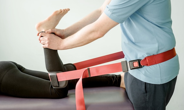 Photo physical therapy treatment using mulligan mobilisation belt, joint mobilisation and pain treatment