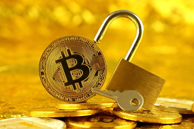 Physical version of bitcoin new virtual money and golden padlock conceptual image for money and cryptocurrency security