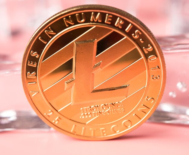 Physical version of golden Litecoin on light background new virtual money Cryptocurrency