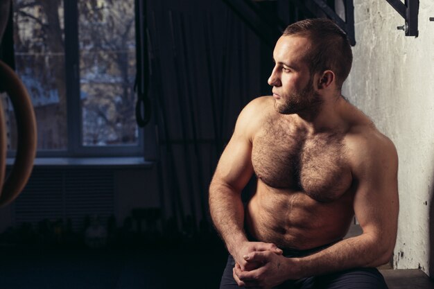 Physically Fit Man posing In A Health Club