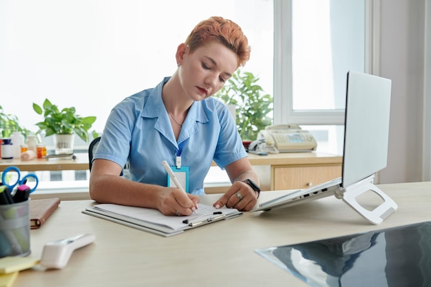 Physician Filling Medical Card