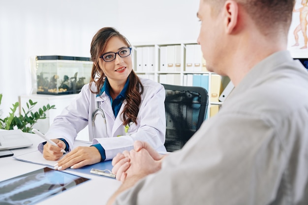 Physician listening to patient