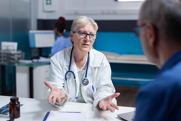 Physician and man meeting at checkup appointment to do healthcare consultation