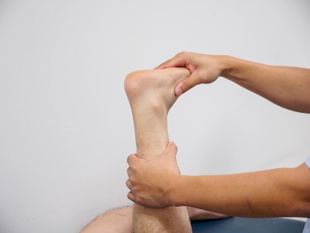 Photo a physician prepares to bandage a patients foot for cast immobilization  orthopedic surgery