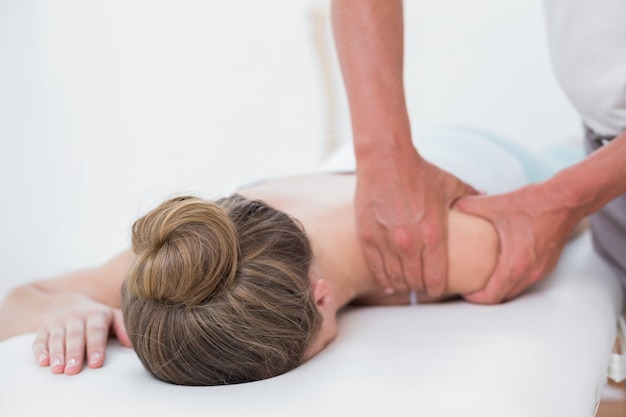 Physiotherapist doing arm massage to his patient