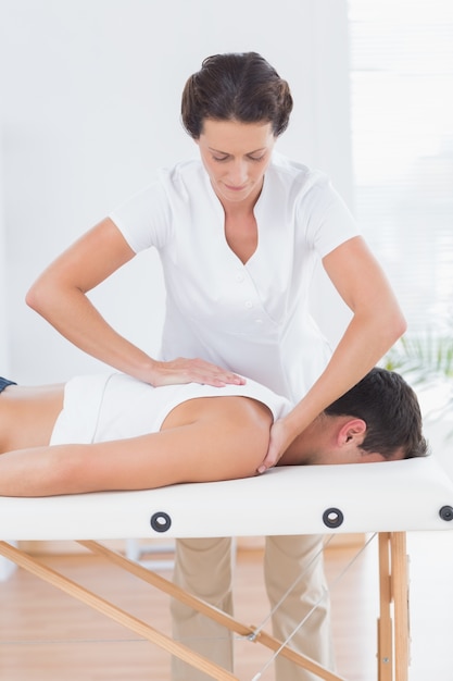 Physiotherapist doing back massage 