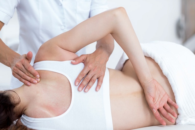 Physiotherapist doing back massage 