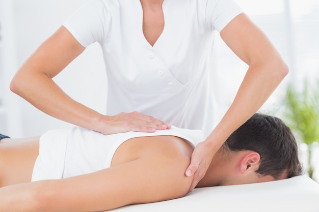 Physiotherapist doing back massage 