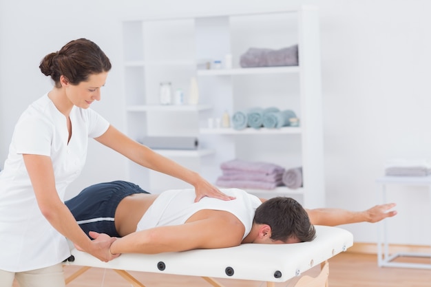 Physiotherapist doing back massage 