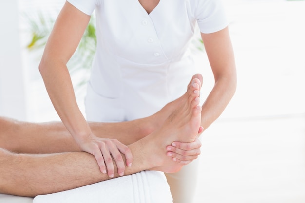 Physiotherapist doing foot massage 