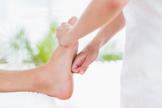 Physiotherapist doing foot massage 