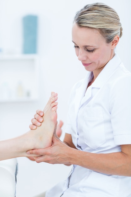 Physiotherapist doing foot massage