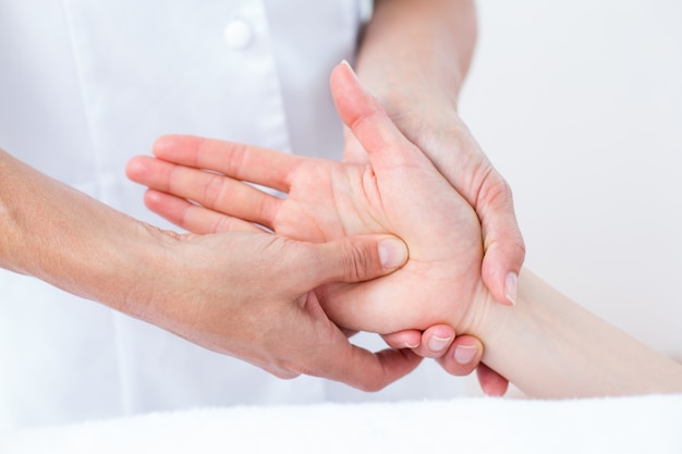 Physiotherapist doing hand massage 