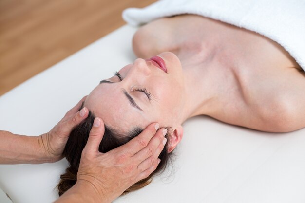 Physiotherapist doing head massage 