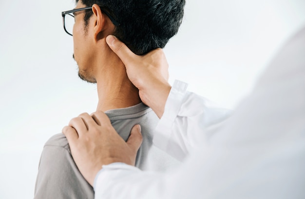 Physiotherapist doing healing treatment on man's neck, Chiropractic adjustment