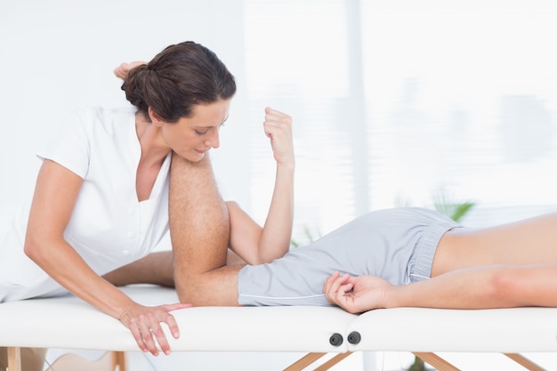 Physiotherapist doing leg massage to her patient