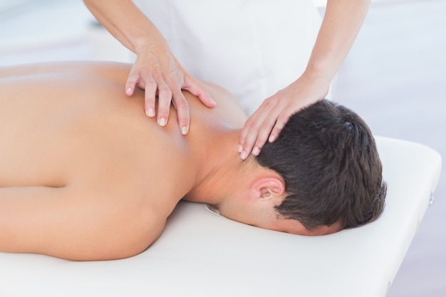 Physiotherapist doing neck massage to her patient