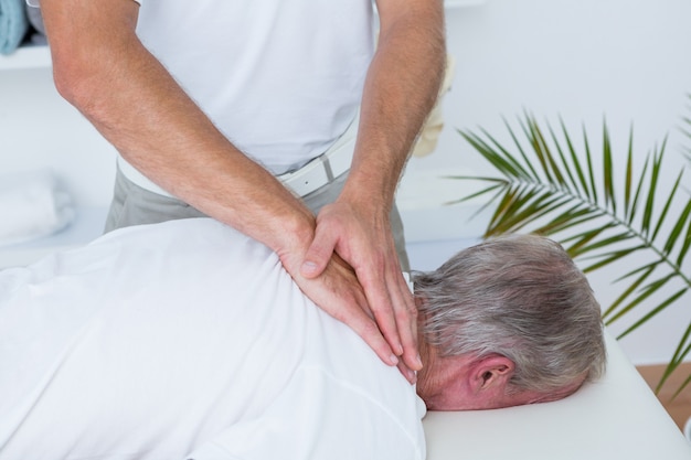 Premium Photo Physiotherapist Doing Neck Massage To His Patient