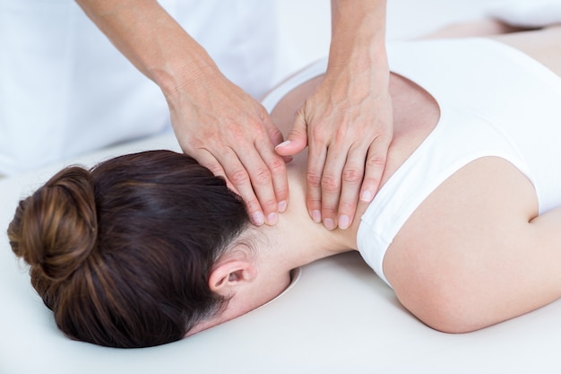 Physiotherapist doing neck massage 