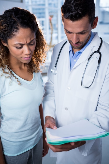 Physiotherapist explaining diagnosis to female patient