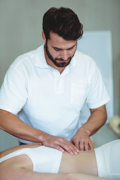 Physiotherapist giving back massage to a woman