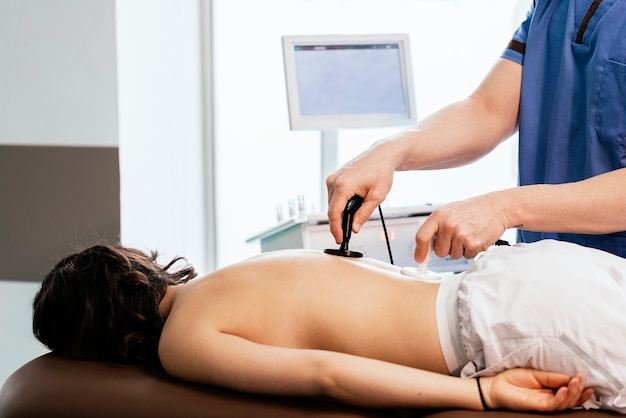 Фото Физиотерапевт дает терапию на спине женщине в клинике. концепция физического лечения