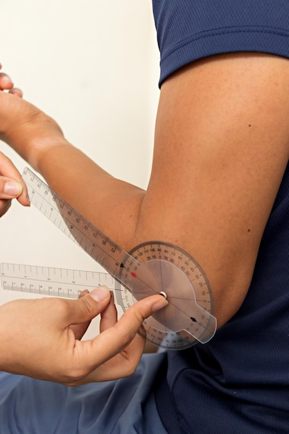 Physiotherapist measuring the angle of an arm