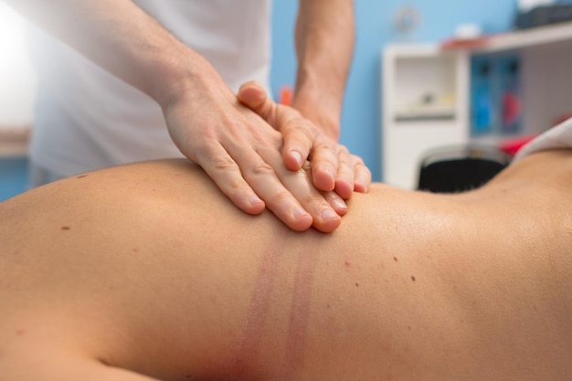 Physiotherapist performs a back massage