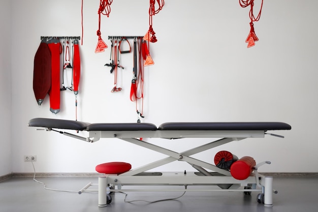 Physiotherapist\'s office with suspension therapy system red\
cord for treatment and rehabilitation