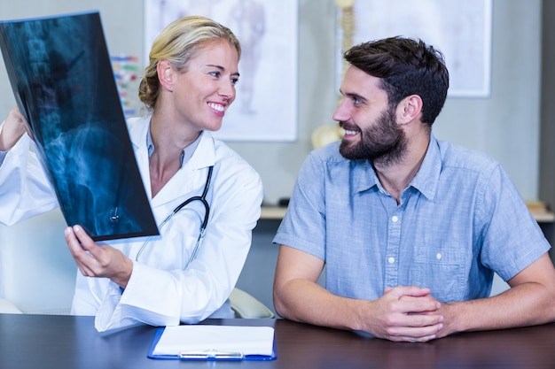 Physiotherapist showing x-ray to a patient