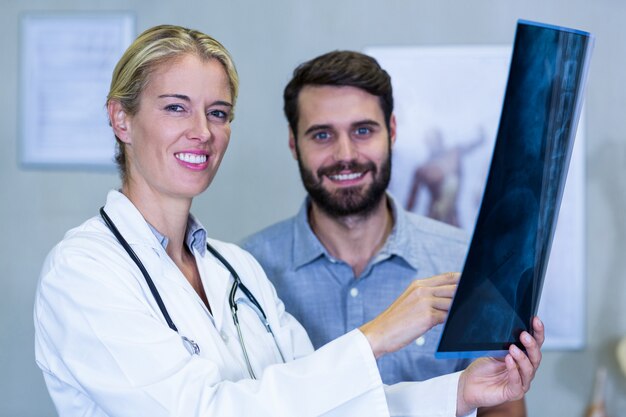 Physiotherapist showing x-ray to a patient