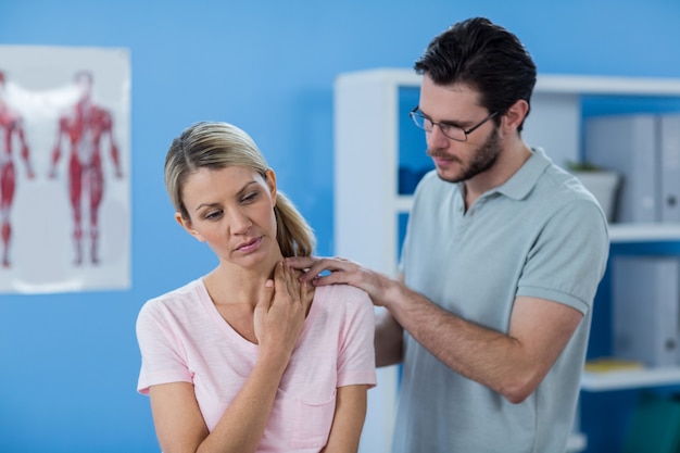 Physiotherapist stretching neck of a female patient