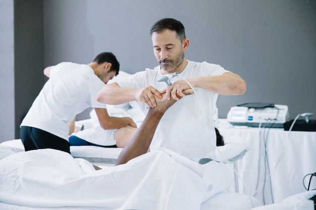 The physiotherapist treating a man