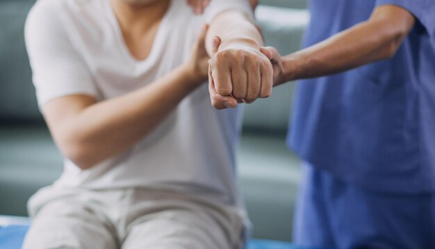 Physiotherapist working with patient in clinic closeup