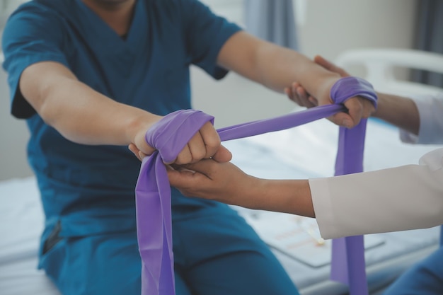 Physiotherapist working with patient in clinic closeup