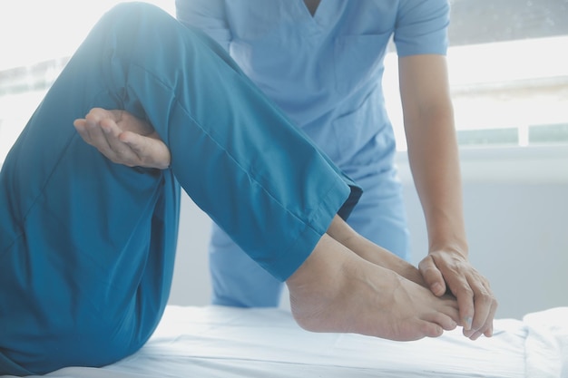 Physiotherapist working with patient in clinic closeup