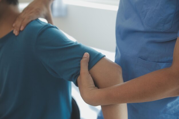 Physiotherapist working with patient in clinic closeup