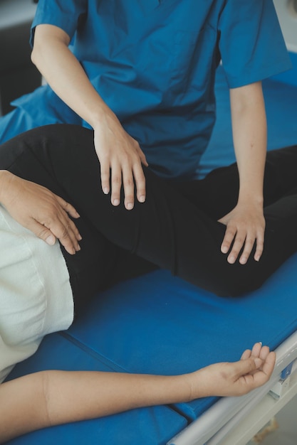 Physiotherapist working with patient in clinic closeup