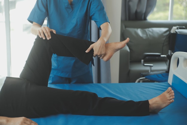 Physiotherapist working with patient in clinic closeup