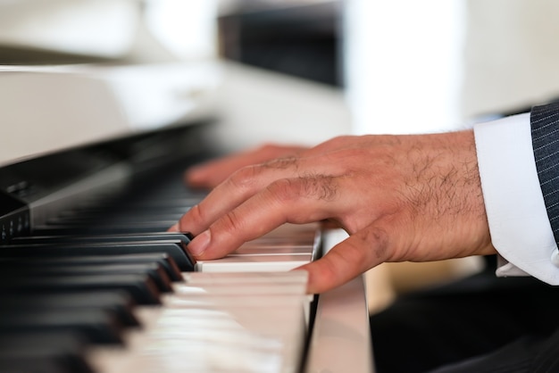 Pianist on a piano creates a beautiful musical Atmosphere in a fine dining restaurant