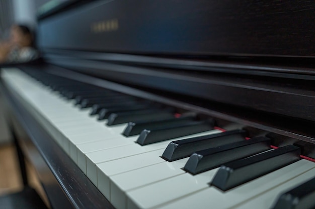 Piano keyboard background with selective focus Warm color toned image Classic grand piano keyboard closeup