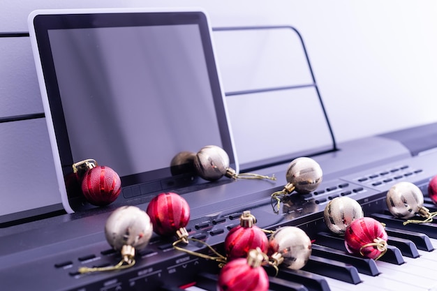 Piano keyboard with Christmas garland close up