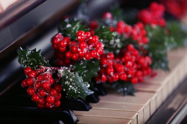 Piano keys decorated with Christmas decorations, close up