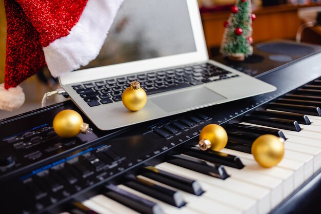 Piano keys decorated with golden Christmas decorations